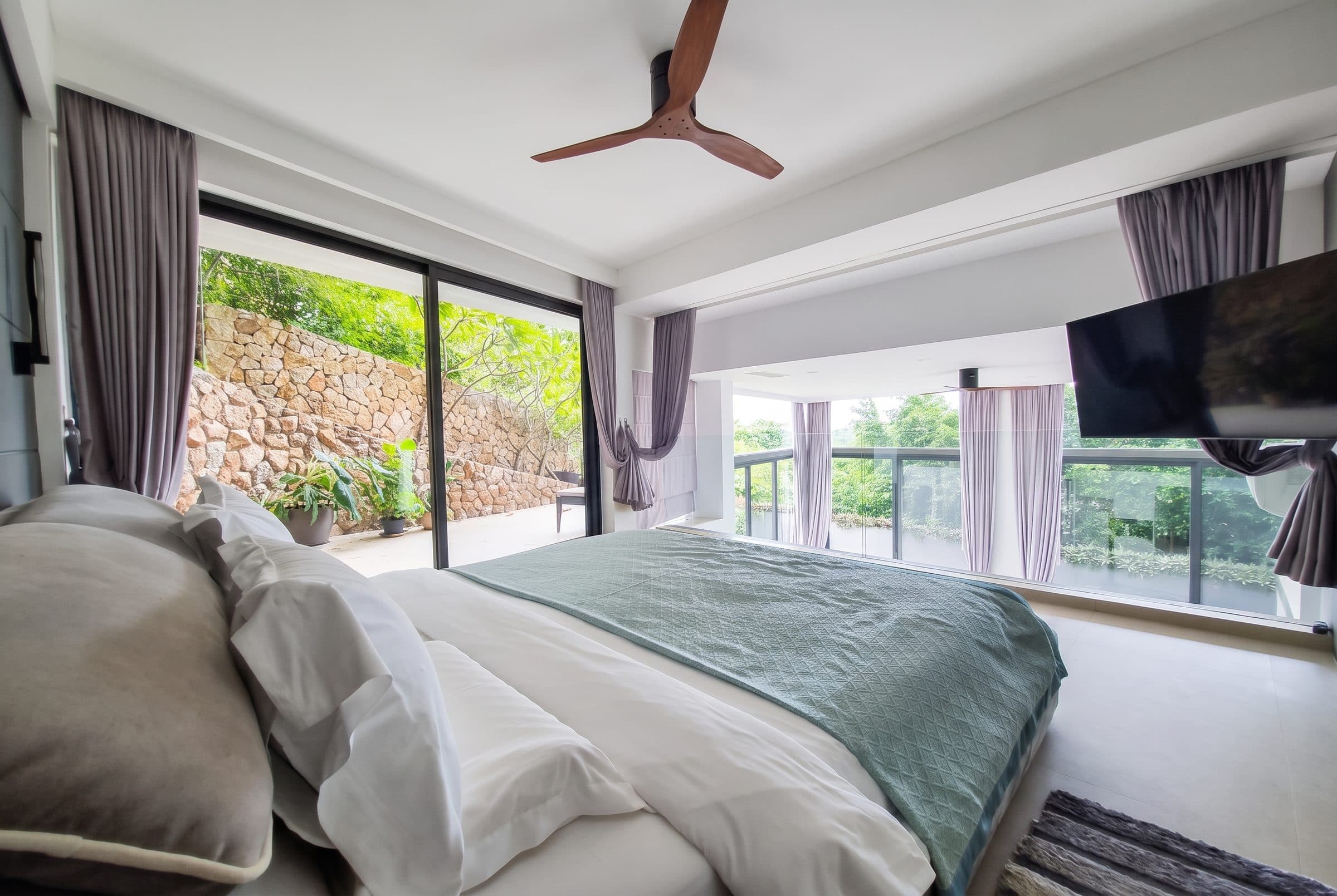 Bedroom opening onto the terrace and tropical garden