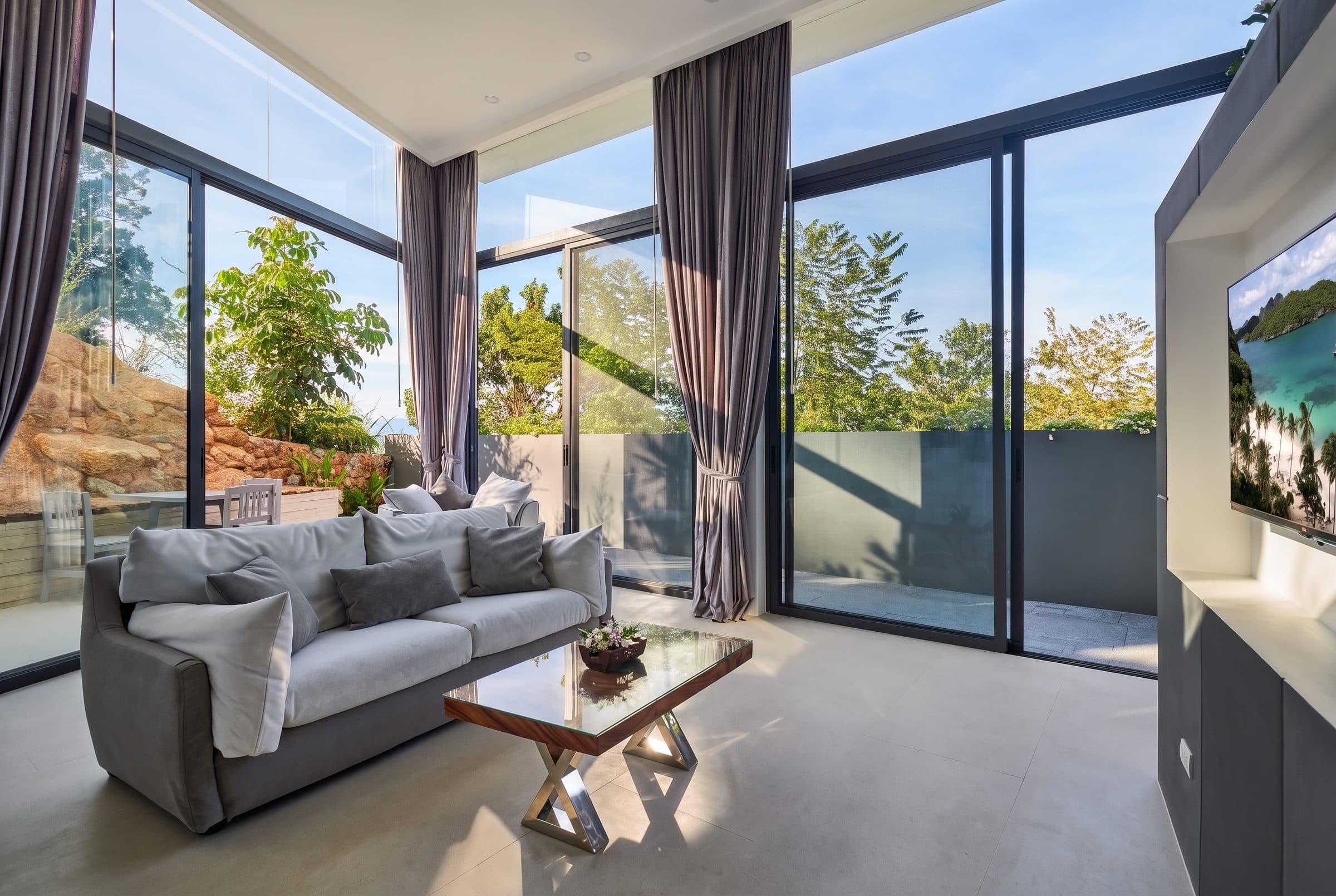 Garden Suite living room with floor-to-ceiling glass and garden views