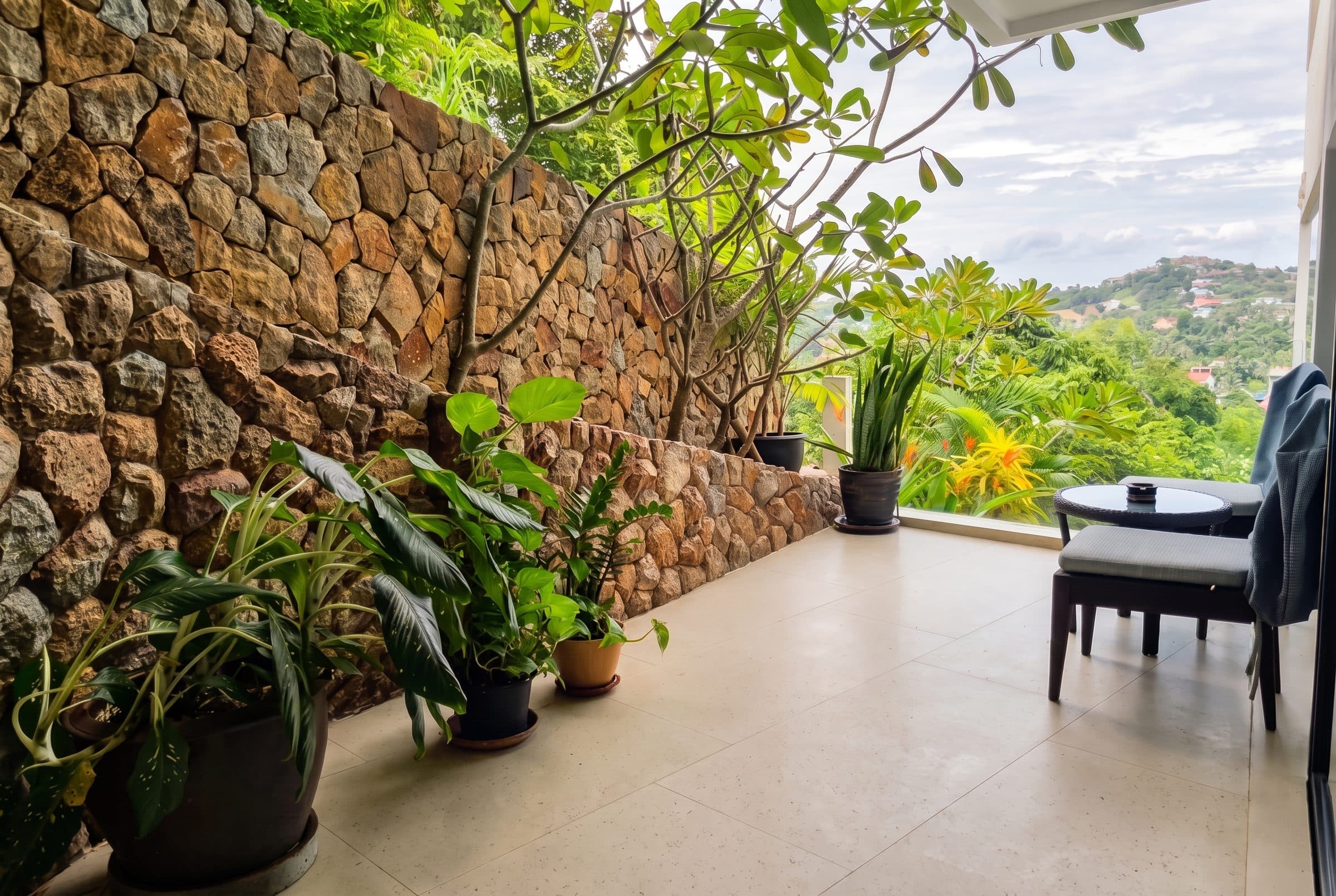 Private terrace with natural stone wall and tropical plants