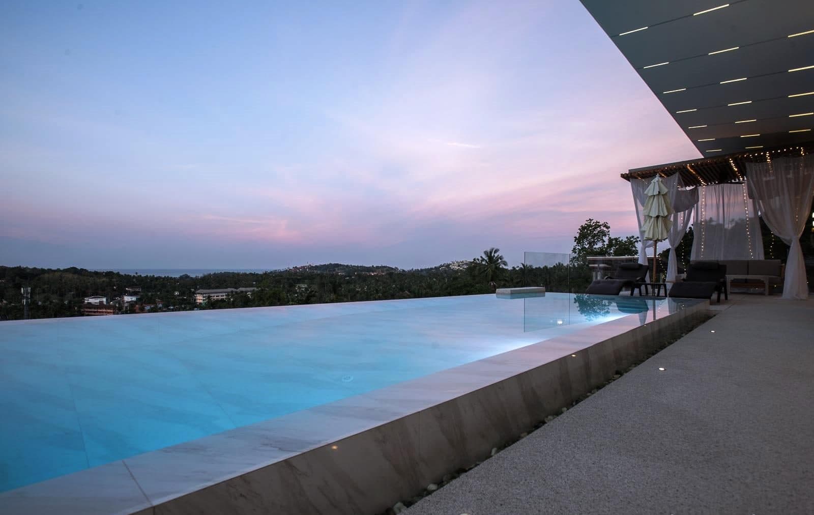Infinity edge pool at dusk overlooking the bay