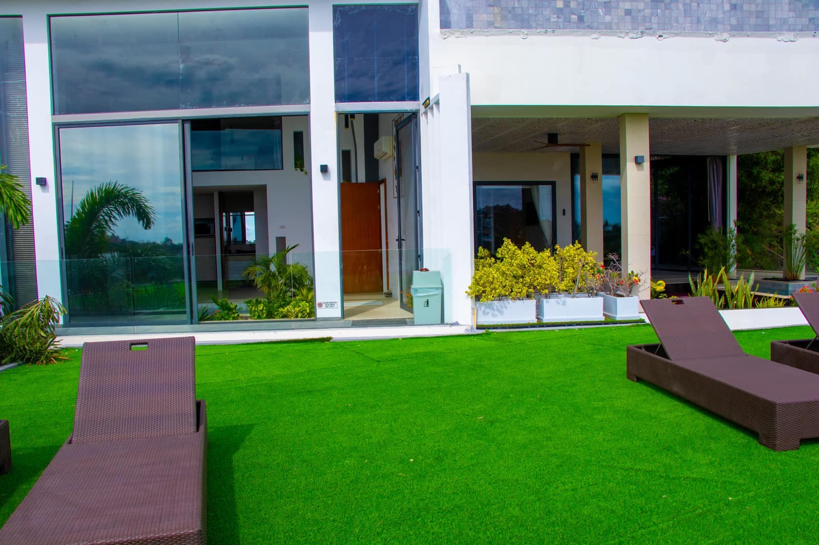 Island view villa lawn with sun loungers