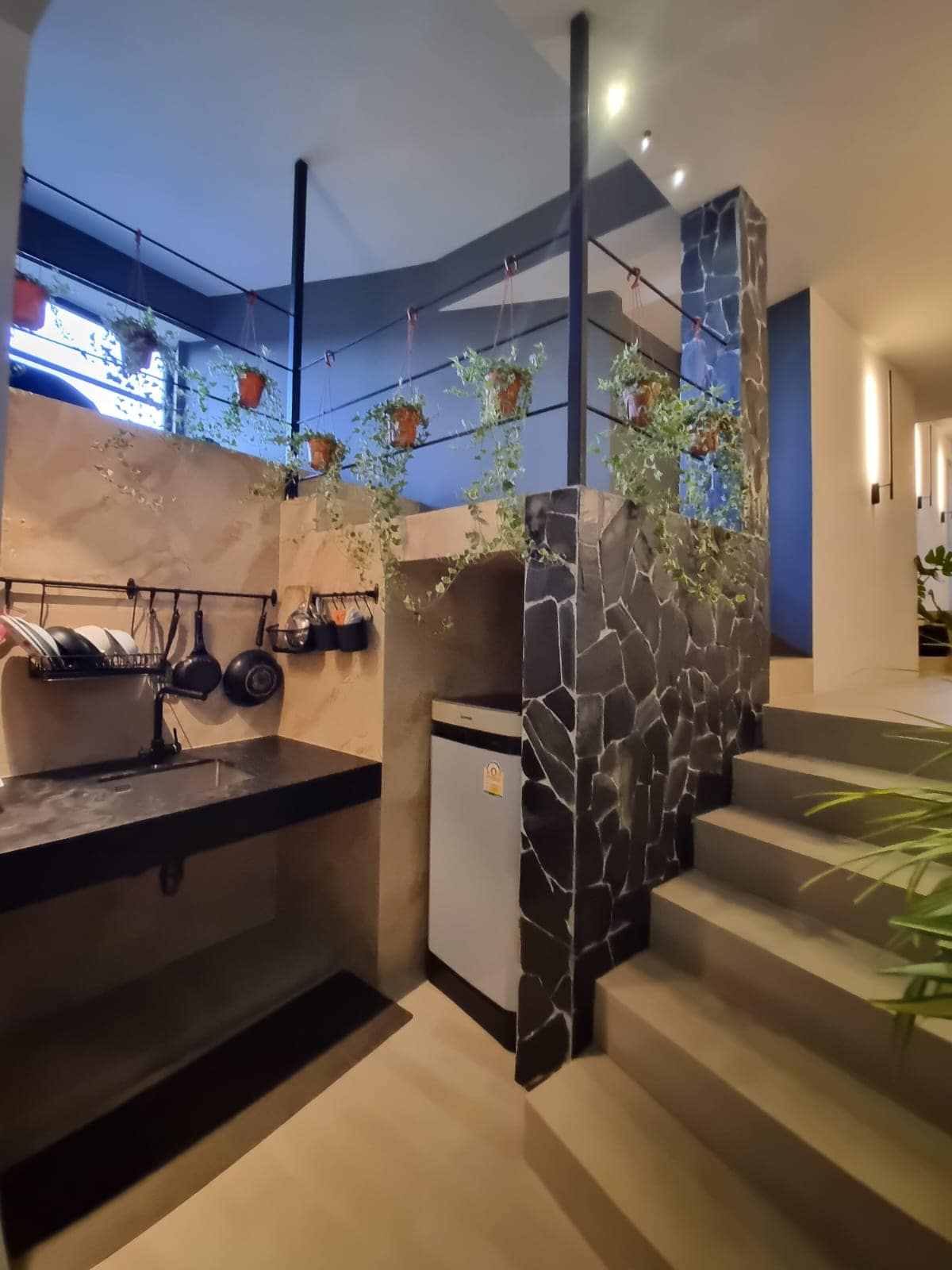 Lower-level kitchenette by the stone staircase