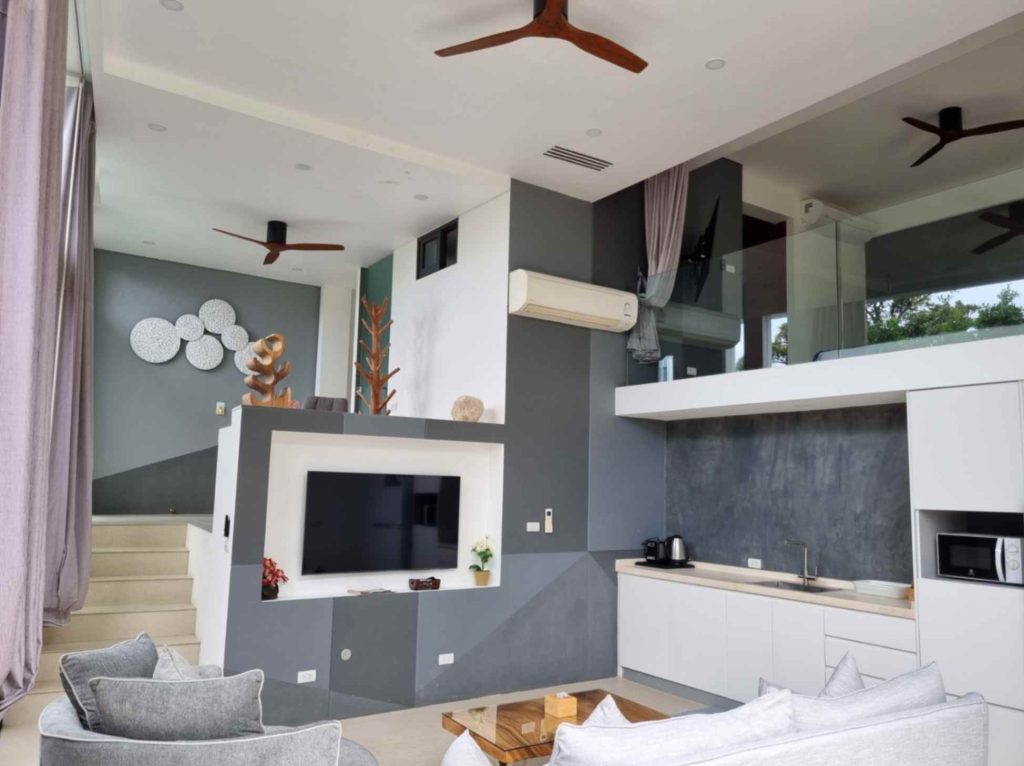 An expansive look at the modern ground floor of the Garden Suite, featuring a stylish living room and kitchen.