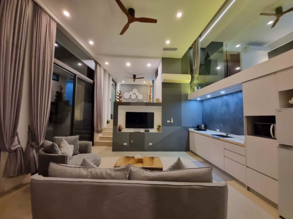 Stunning view of the ground floor of the Garden Suite, featuring a modern lounge, kitchen and other amenities.