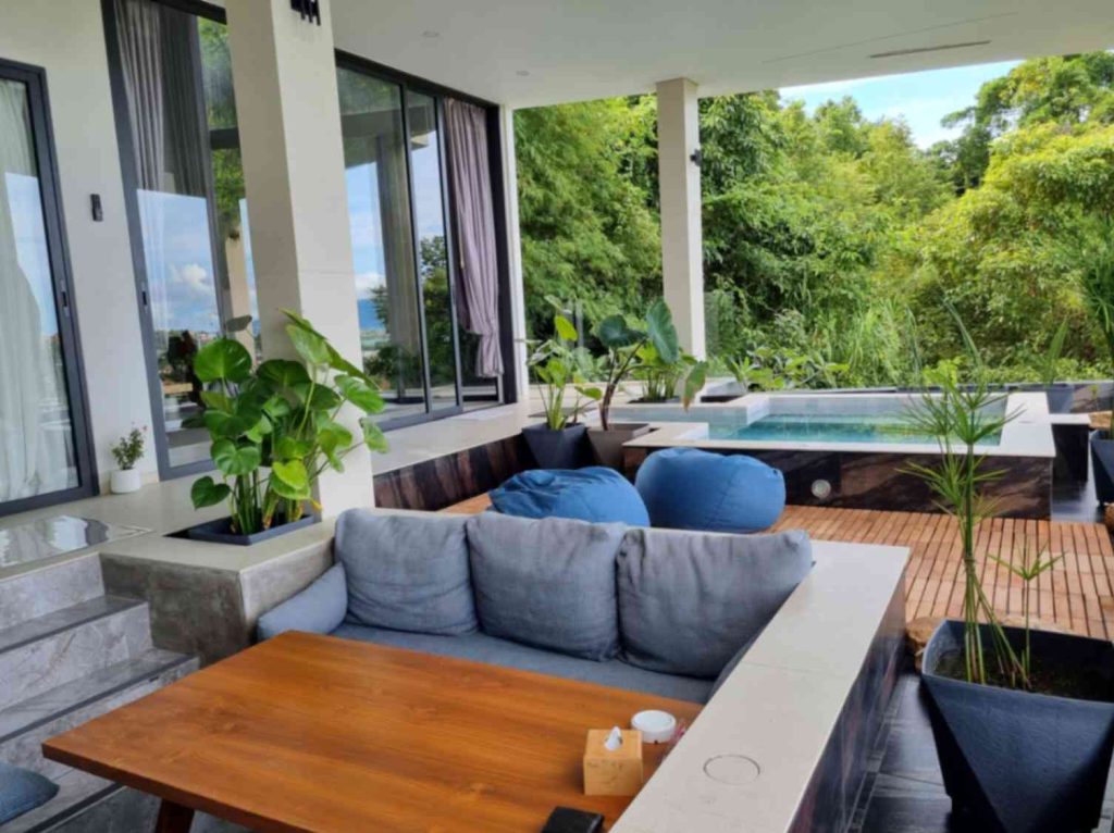 Spacious and comfy lounge area of the Garden Suite, featuring greenery in the background.