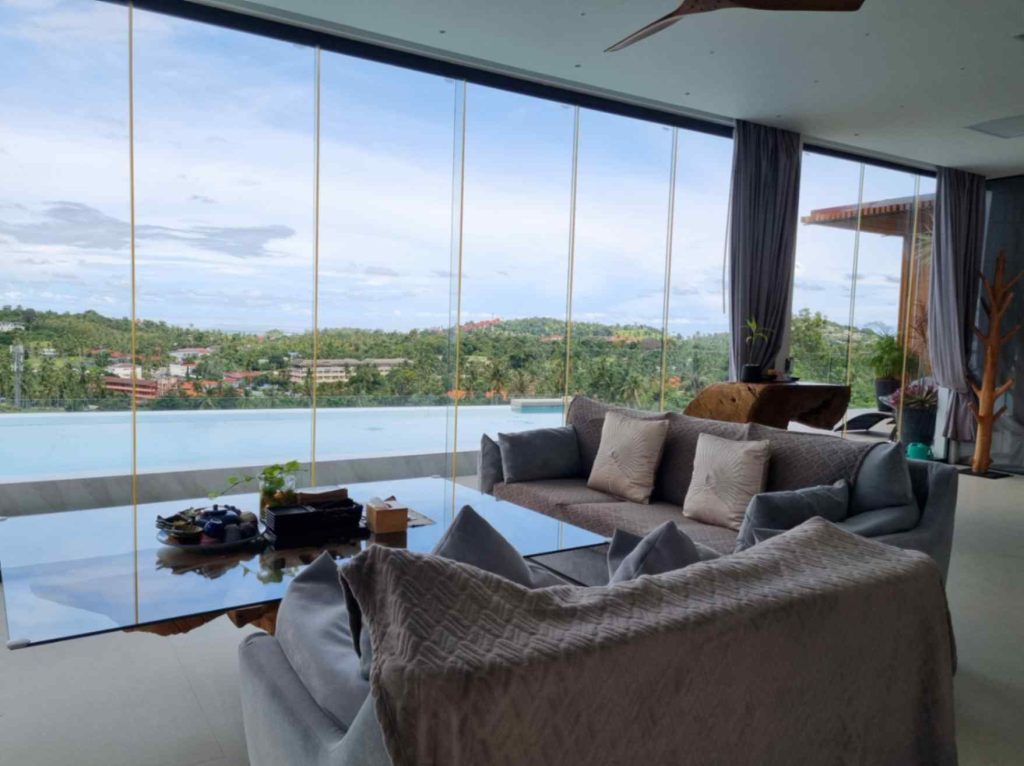 Spacious Magic Suites honeymoon suite with panoramic glass views and elegant decor.