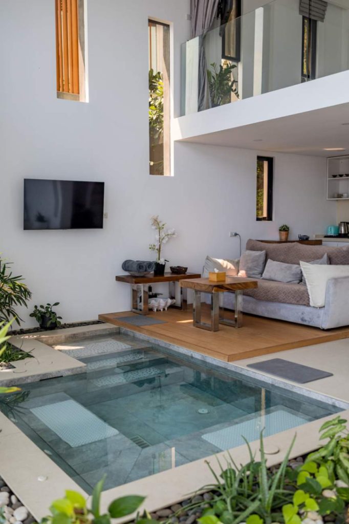 Vertical snapshot of the Sunrise Suite's living space featuring an interior tranquility pool.