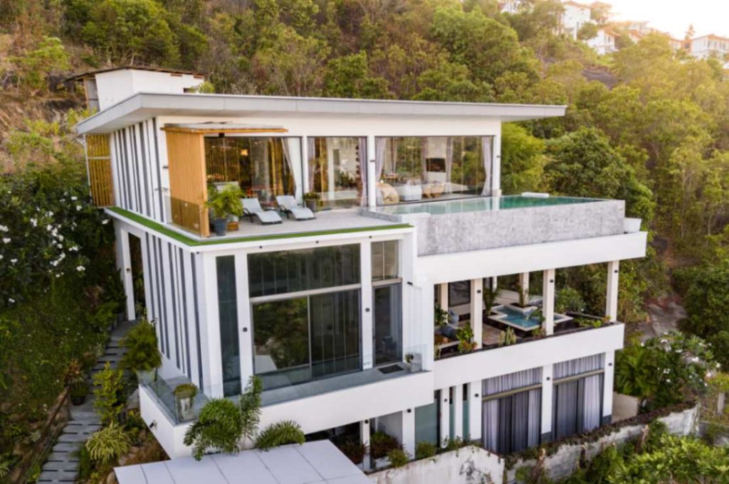 Elegant multi-level Magic Suites villa in Koh Samui surrounded by lush greenery.