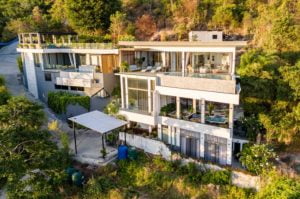 Aerial view of Magic Suites villa nestled in lush greenery in Koh Samui, showcasing modern design.