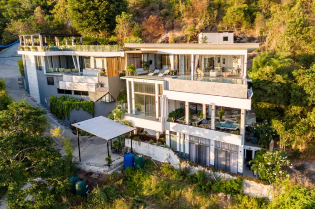 Aerial view of Magic Suites villa nestled in lush greenery in Koh Samui, showcasing modern design.