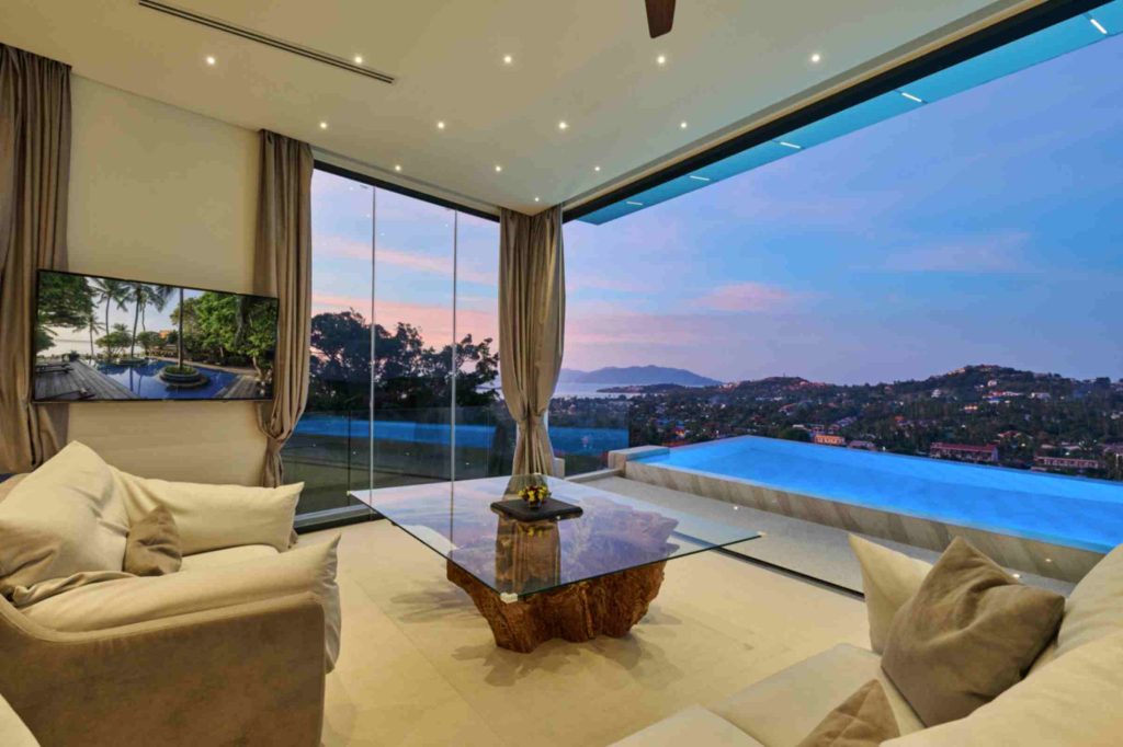 View from the modern living room of the Magic Honeymoon Suite, with the pool in the background.