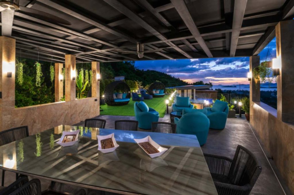 View of the beautiful Garden Suite overlooking an outside seating area with an elegant dining table in the foreground.