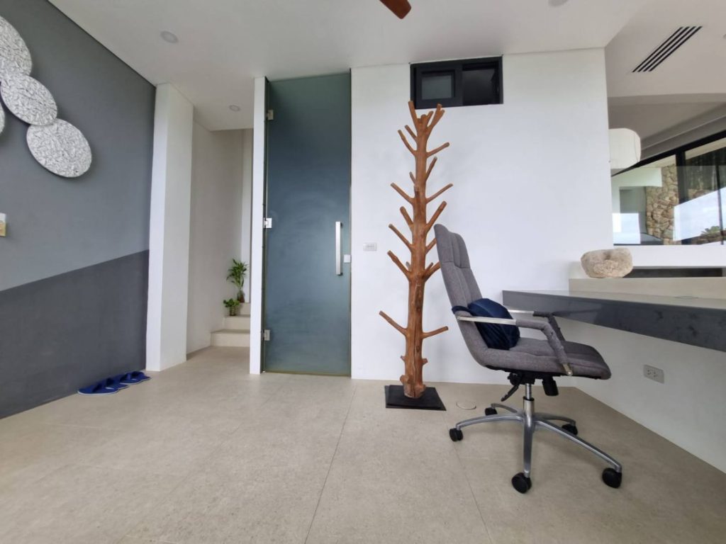 A room in the modern Garden Suite, featuring a table and chair.